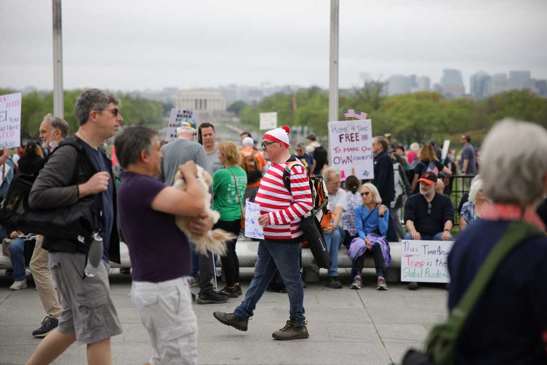 A demonstrator is dressed as the fictional character 'Waldo' during the 'Hands Off' protest against the Trump administration on the National Mall in Washington, D.C. on April 5.