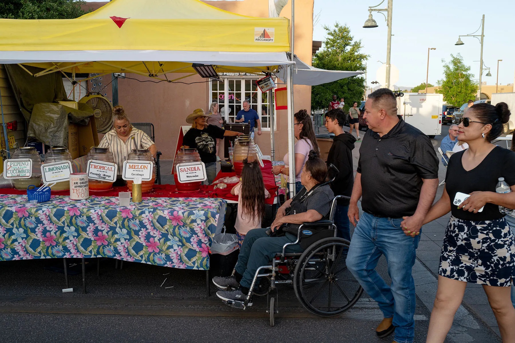 People walk by a vendor stand.