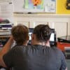 Sam, age 6, and his mother, Tabitha, attend a virtual class with Sam’s teacher of the deaf and hard of hearing.