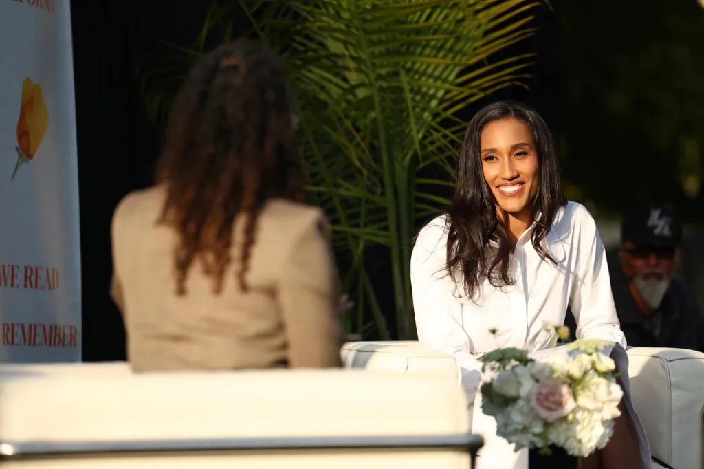 Anna Malaika Tubbs smiles on stage at the VIP preview of her new book, Erased.